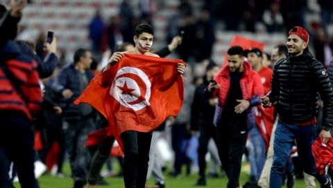 Tunisian supporters invade the pitch after a friendly soccer match between Tunisia and Costa Rica at the Allianz Riviera stadium in Nice, southern France, Tuesday, March 27, 2018. (AP Photo/Claude Paris)