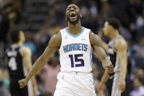 FILE - In this March 26, 2019, file photo, Charlotte Hornets' Kemba Walker (15) reacts after making a basket against the San Antonio Spurs during the second half of an NBA basketball game in Charlotte, N.C. The three-time All-Star point says hed be willing to work with the Hornets and take less than the supermax $221 million contract hes eligible to receive to re-sign with Charlotte (AP Photo/Chuck Burton, File)