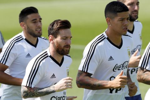 Marcos Rojo, right, and Lionel Messi jog during a training session of Argentina at the 2018 soccer World Cup in Bronnitsy, Russia, Thursday, June 28, 2018. (AP Photo/Ricardo Mazalan)