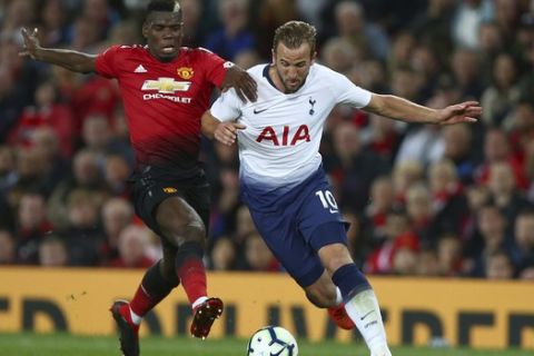 Tottenham Hotspur's Harry Kane, right, is challenged by Manchester United's Paul Pogba during the English Premier League soccer match between Manchester United and Tottenham Hotspur at Old Trafford stadium in Manchester, England, Monday, Aug. 27, 2018. (AP Photo/Dave Thompson)