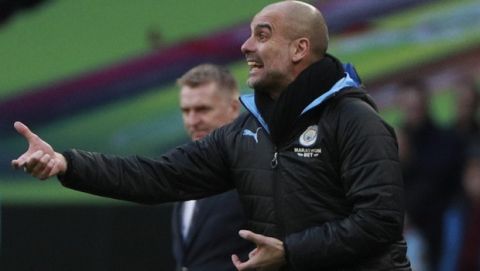 Manchester City's head coach Pep Guardiola gives directions to his players during the League Cup soccer match final between Aston Villa and Manchester City, at Wembley stadium, in London, England, Sunday, March 1, 2020. (AP Photo/Ian Walton)