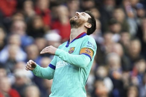 Barcelona's Lionel Messi reacts after missing a scoring chance during the Spanish La Liga soccer match between Valencia and Barcelona at the Mestalla Stadium in Valencia, Spain, Saturday, Jan. 25, 2020. (AP Photo/Alberto Saiz)