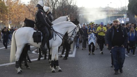 Mounted police officers escort Boca Juniors supporters ahead of the Copa Libertadores Final between River Plate and Boca Juniors in Madrid, Sunday, Dec. 9, 2018. Tens of thousands of Boca and River fans are in the city for the "superclasico" at Santiago Bernabeu Stadium on Sunday. (AP Photo/Emilio Morenatti)