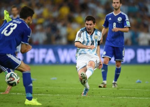 RIO DE JANEIRO, BRAZIL - JUNE 15: Lionel Messi of Argentina shoots and scores his team's second goal during the 2014 FIFA World Cup Brazil Group F match between Argentina and Bosnia-Herzegovina at Maracana on June 15, 2014 in Rio de Janeiro, Brazil.  (Photo by Matthias Hangst/Getty Images)