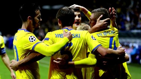 BATE's players celebrate after scoring the opening goal during the Champions League play-off round, 1st leg soccer match between Bate and PSV at the Borisov-Arena stadium in Borisov, Belarus, Tuesday, Aug. 21, 2018. (AP Photo/Sergei Grits)