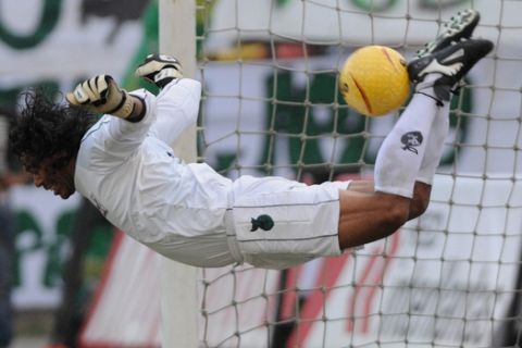 Goalkeeper Rene Higuita kicks the ball during his farewell match between a team of Colombia all-stars and top players from the 1990s of the Colombian club Atletico Nacional in Medellin, Colombia, Sunday, Jan. 24, 2010.  Higuita, 43, was famous for his frizzy hair and daring moves in goal. (AP Photo/Luis Benavides)