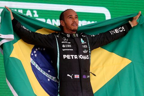 Mercedes driver Lewis Hamilton, of Britain, celebrates his victory after coming in first in the Brazilian Formula One Grand Prix in Sao Paulo, Brazil, Sunday, Nov. 14, 2021. (Lars Baron, Pool Photo via AP)