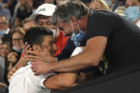 Serbia's Novak Djokovic celebrates with Goran Ivanisevic, right, and his support team after defeating Russia's Daniil Medvedev in the men's singles final at the Australian Open tennis championship in Melbourne, Australia, Sunday, Feb. 21, 2021.(AP Photo/Andy Brownbill)