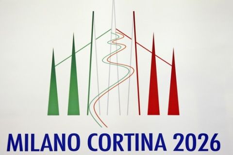 The Milan-Cortina winter Olympic logo is shown during a winter Olympics Milan Cortina bid IOC Evaluation Commission final news conference, in Milan, Italy, Saturday, April 6, 2019. At right is President of the Italian National Olympic Committee, CONI, Giovanni Malago'. The Milan-Cortina d'Ampezzo bid for the 2026 Winter Olympics has been boosted by a key letter of financial support from the Italian government. The letter signed by Italian Premier Giuseppe Conte was delivered to Octavian Morariu, the chair of the IOC's evaluation commission, which is concluding a weeklong inspection of the bid sites. (AP Photo/Luca Bruno)