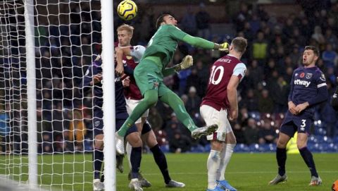 West Ham United goalkeeper Roberto, centre, scores an own goal, during the English Premier League soccer match between Burnley and West Ham United, at Turf Moor, in Burnley, England,  Saturday, Nov. 9, 2019. (Ian Hodgson/PA via AP)