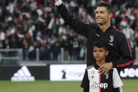 Juventus' Cristiano Ronaldo with his son Cristiano Jr prior to the Serie A soccer match between Juventus and Atalanta at the Allianz stadium, in Turin, Italy, Sunday, May 19, 2019. (AP Photo/Antonio Calanni)
