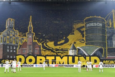 Dortmund's fans cheer prior to the German Bundesliga soccer match between Borussia Dortmund and Eintracht Frankfurt in Dortmund, Germany, Friday, Feb. 14, 2020. (AP Photo/Martin Meissner)