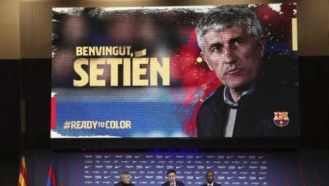 Quique Setien, left, joins FC Barcelona's President Josep Maria Bartomeu, center, and director of football Eric Abidal, right, in a news conference after being officially introduced as the new soccer coach of FC Barcelona at the Camp Nou stadium in Barcelona, Spain, Tuesday, Jan. 14, 2020. Barcelona made a rare coaching change midway through the season, replacing Ernesto Valverde with former Real Betis manager Quique Setien on Monday. (AP Photo/Emilio Morenatti)