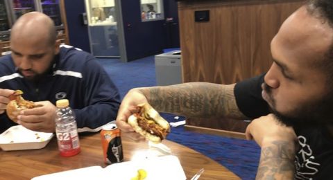 In this image made from video, Tennessee Titans defensive lineman DaQuan Jones, left, and defensive end Jurrell Casey eat vegetarian cheeseburgers provided by chef Charity Morgan, wife of Titans linebacker Derrick Morgan, in the Titans locker room in Nashville on Sunday, Dec. 3, 2017. Tennessees defense has a secret weapon this season, and players say its delicious. Eleven Titans have gone vegan or vegetarian, eating lunches delivered by the Cordon-Bleu-trained wife of linebacker Morgan. In a sport where players have a carnivorous reputation, the veggie-fueled Titans boast one of the leagues better defenses. Linebacker Wesley Woodyard says he has more energy since turning to milk-less cereal, veggie burgers and vegan crabcakes. (AP Photo/Teresa Walker)