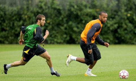 Arsenal's Thierry Henry, right, of France is chased by his compatriot Mathieu Flamini during a training session at the club's training facilities in north London, Monday May 15, 2006.  Arsenal are due to play Barcelona in the final of the Champions League in Paris on Wednesday.  (AP Photo/Matt Dunham)