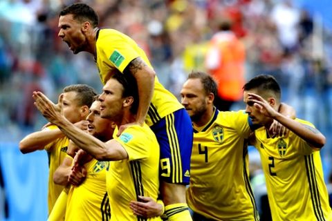 Sweden's players celebrate the opening side's goal during the round of 16 match between Switzerland and Sweden at the 2018 soccer World Cup in the St. Petersburg Stadium, in St. Petersburg, Russia, Tuesday, July 3, 2018. (AP Photo/Efrem Lukatsky)