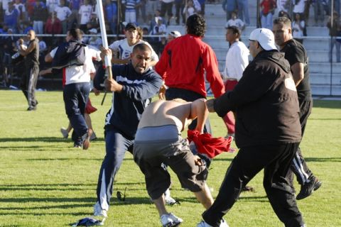 Fans of soccer teams Danubio and Nacional fight on the field after their Uruguayan league soccer match in Montevideo, Sunday, Nov. 16, 2008. Uruguay's football authorities have suspended play in all divisions until further notice due to an on-field fight involving more than 100 fans of the two first-division teams. (AP Photo/Leo Maine)
