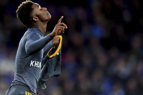 Leicester City's Demarai Gray with a shirt that reads 'For Khun Vichai' celebrates scoring his side's first goal of the game during the English Premier League soccer match between Cardiff City and Leicester City at the Cardiff City Stadium, Cardiff. Wales. Saturday Nov. 3, 2018. (Simon Galloway/PA via AP)