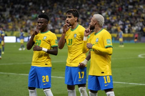Brazil's Lucas Paqueta, center, celebrates with teammates Vini Jr, left, and Neymar after scoring his side's opening goal against Colombia during a qualifying soccer match for the FIFA World Cup Qatar 2022 at Neo Quimica Arena stadium in Sao Paulo, Brazil, Thursday, Nov.11, 2021. (AP Photo/Andre Penner)