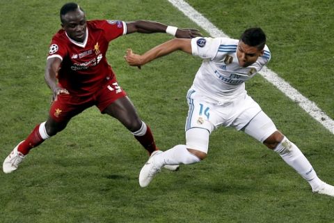 Liverpool's Sadio Mane, left, and Real Madrid's Casemiro, right, challenge for the ball during the Champions League Final soccer match between Real Madrid and Liverpool at the Olimpiyskiy Stadium in Kiev, Ukraine, Saturday, May 26, 2018. (AP Photo/Darko Vojinovic)