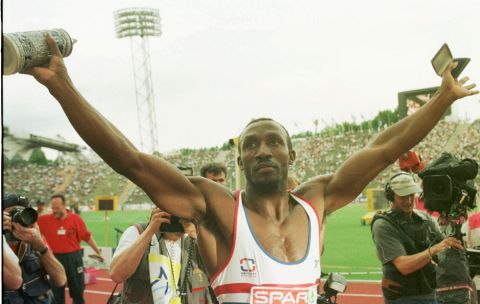 Sprinting legend Linford Christie holds his trophy, a Bavarian beerstein, in his right hand Saturday. June 21, 1997 after winning the 100 meter race at the track and field Eurocup final in Munich's Olympic stadium. (AP Photo/Frank Augstein)