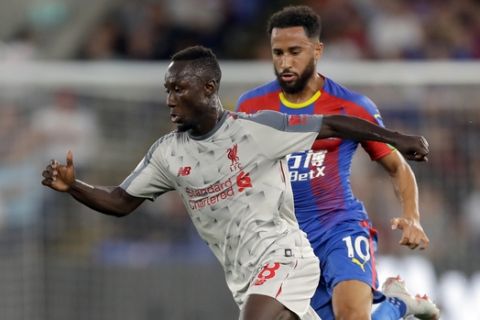 Liverpool's Naby Keita, front, and Crystal Palace's Andros Townsend run for the ball during the English Premier League soccer match between Crystal Palace and Liverpool at Selhurst Park stadium in London, Monday, Aug. 20, 2018. (AP Photo/Kirsty Wigglesworth)