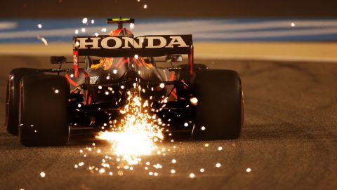 BAHRAIN, BAHRAIN - MARCH 26: Sparks fly behind Sergio Perez of Mexico driving the (11) Red Bull Racing RB16B Honda during practice ahead of the F1 Grand Prix of Bahrain at Bahrain International Circuit on March 26, 2021 in Bahrain, Bahrain. (Photo by Lars Baron/Getty Images)