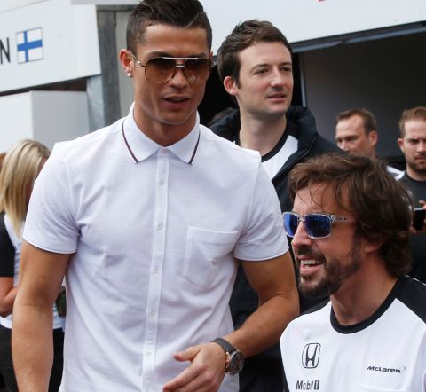 Soccer star player Cristiano Ronaldo, left, shares a word with McLaren driver Fernando Alonso, of Spain, during a photo call at the McLaren pits prior to the start of the Formula One Grand Prix, at the Monaco racetrack, in Monaco, Sunday, May 24, 2015.(AP Photo/Luca Bruno)