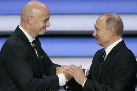 FIFA president Gianni Infantino, left, and Russian President Vladimir Putin shakes hands at the 2018 soccer World Cup draw in the Kremlin in Moscow, Friday, Dec. 1, 2017. (AP Photo/Ivan Sekretarev)