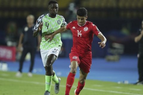 Tunisia's Drager Mohamed and Nigeria's Nididi Wilfred fight for the ball during the African Cup of Nations third place soccer match between Nigeria and Tunisia in Al Salam stadium in Cairo, Egypt, Wednesday, July 17, 2019. (AP Photo/Hassan Ammar)