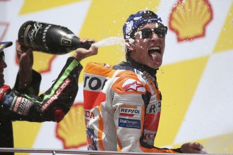 Honda rider Marc Marquez of Spain sprays champagne after winning the Malaysia MotoGP at the Sepang International Circuit in Sepang, Malaysia, Sunday, Nov. 4, 2018. (AP Photo/Vincent Phoon)