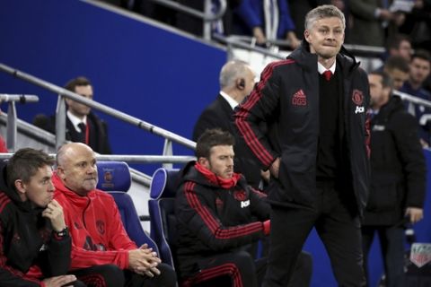 Manchester United Interim Manager Ole Gunnar Solskjaer foreground, watches the action from the touchline as coaching staff Kieran McKenna (left) Mike Phelan and Michael Carrick sit behind him during the English Premier League soccer match between Cardiff City and Manchester United at the Cardiff City Stadium, in Cardiff, Wales, Saturday, Dec. 22, 2018. (Nick Potts/PA via AP)