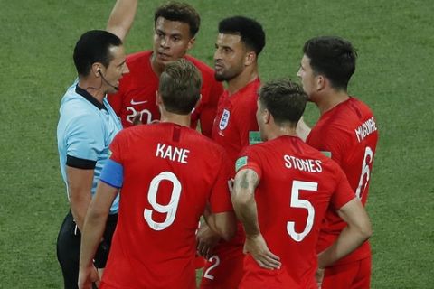 England's Kyle Walker, center, gets a yellow card during the group G match between Tunisia and England at the 2018 soccer World Cup in the Volgograd Arena in Volgograd, Russia, Monday, June 18, 2018. (AP Photo/Rebecca Blackwell)