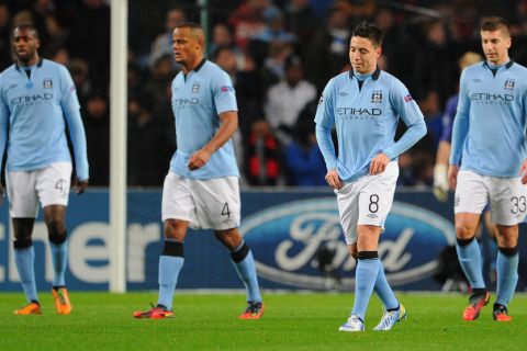 MANCHESTER, ENGLAND - NOVEMBER 21:  Samir Nasri of Manchester City and his team-mates look dejected after conceding the opening goal during the UEFA Champions League Group D match between Manchester City FC and Real Madrid CF at the Etihad Stadium on November 21, 2012 in Manchester, England. (Photo by Michael Regan/Getty Images)