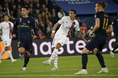 PSG's Angel Di Maria, center, scores his side's second goal during the Champions League group A soccer match between PSG and Real Madrid at the Parc des Princes stadium in Paris, Wednesday, Sept. 18, 2019. (AP Photo/Francois Mori)