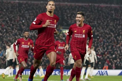 Liverpool's Virgil van Dijk, left, celebrates scoring his side's first goal during the English Premier League soccer match between Liverpool and Manchester United at Anfield Stadium in Liverpool, Sunday, Jan. 19, 2020.(AP Photo/Jon Super)