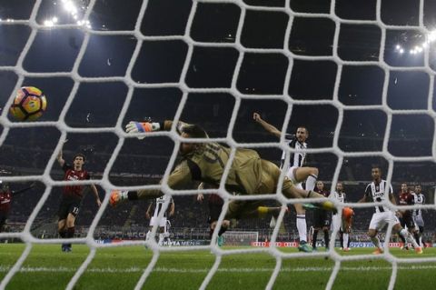 AC Milan goalkeeper Gianluigi Donnarumma vainly reaches for the ball on a goal by Juventus Miralem Pjanic that was later disallowed, during a Serie A soccer match between AC Milan and Juventus, at the San Siro stadium in Milan, Italy, Saturday, Oct. 22, 2016. (AP Photo/Luca Bruno)