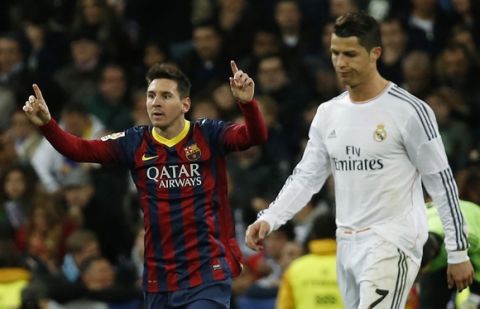Barcelona's Lionel Messi (L) celebrates a goal next to Real Madrid's Cristiano Ronaldo during La Liga's second 'Clasico' soccer match of the season at Santiago Bernabeu stadium in Madrid March 23, 2014.  REUTERS/Paul Hanna (SPAIN - Tags: SPORT SOCCER TPX IMAGES OF THE DAY)