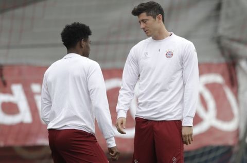 Bayern's Robert Lewandowski, right, closes his eyes besides team mate David Alaba during a training session prior to the Champions League quarterfinal first leg soccer match between FC Bayern Munich and Real Madrid, in Munich, Germany, Tuesday, April 11, 2017. Munich will face Real on Wednesday. (AP Photo/Matthias Schrader)
