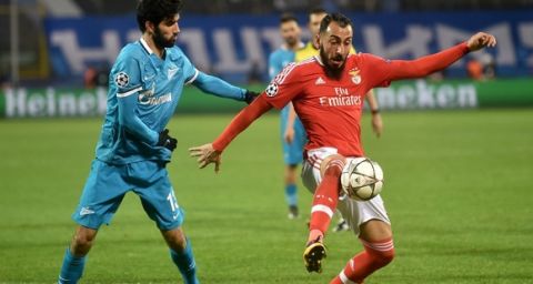 "Zenit's Portuguese defender Luis Neto (L) vies for the ball with Benfica's Greek forward Kostas Mitroglou during the second-leg round of 16 UEFA Champions League football match FC Zenit vs SL Benfica at the Petrovsky stadium in St. Petersburg on March 9, 2016. AFP PHOTO / KIRILL KUDRYAVTSEV / AFP / KIRILL KUDRYAVTSEV        (Photo credit should read KIRILL KUDRYAVTSEV/AFP/Getty Images)"