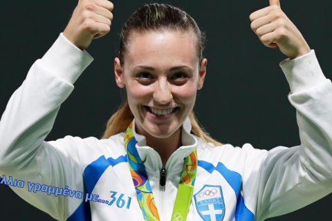 epa05461353 Anna Korakaki of Greece celebrates on the podium after winning the bronze medal in the women's 10m Air Pistol final of the Rio 2016 Olympic Games Shooting events at the Olympic Shooting Centre in Rio de Janeiro, Brazil, 07 August 2016.  EPA/VALDRIN XHEMAJ