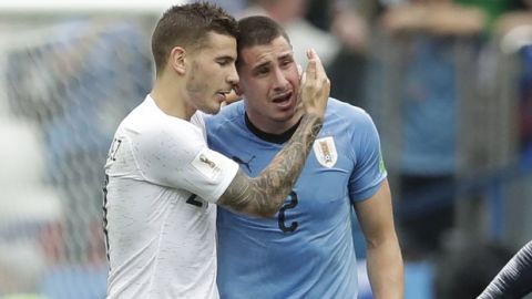 Uruguay's Jose Gimenez, right, is consoled by France's Lucas Hernandez as Uruguay's team loose the quarterfinal match between Uruguay and France at the 2018 soccer World Cup in the Nizhny Novgorod Stadium, in Nizhny Novgorod, Russia, Friday, July 6, 2018. (AP Photo/Petr David Josek)
