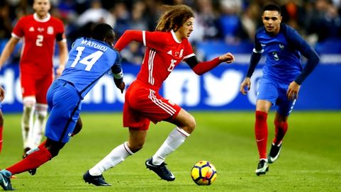 Wales' Ethan Ampadu, center, controls the ball while France's players Blaise Matuidi, left, and Layvin Kurzawa look on during an international friendly soccer match between France and Wales at Stade de France in Saint Denis, a northern suburb of Paris, France, Friday, Nov. 10, 2017. (AP Photo/Francois Mori)
