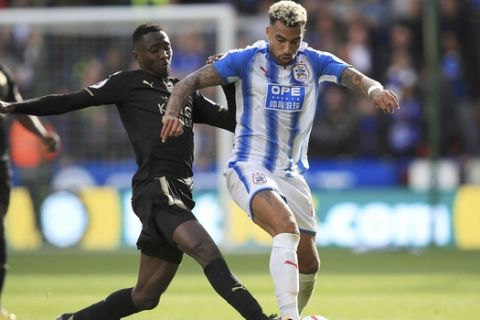 Leicester City's Wilfred Ndidi, left and Huddersfield Town's Danny Williams battle for the ball,  during the English Premier League soccer match between Huddersfield and Leicester City, at the John Smith's Stadium, in Huddersfield, England, Saturday, Sept. 16, 2017. (Mike Egerton/PA via AP)