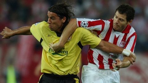 Olympiacos' player Gabriel  Schurrer fights for the ball with Liverpool's Milan Baros, left, during their Champion league, group A  match in Athens Tuesday Sept. 28, 2004.  (AP Photo/Petros Giannakouris)