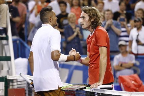 FILE - In this Aug. 3, 2019, file photo, Nick Kyrgios, left, of Australia, and Stefanos Tsitsipas, of Greece, meet at the net after Kyrgios defeated Tsitsipas in a semifinal at the Citi Open tennis tournament in Washington. Tsitsipas sent his tennis mate Kyrgios a special 25th birthday greeting. (AP Photo/Patrick Semansky, File)