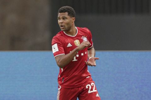 Bayern's Serge Gnabry celebrates after scoring his side's second goal with Bayern's Robert Lewandowski during the German soccer cup (DFB Pokal) final match between Bayer 04 Leverkusen and FC Bayern Munich in Berlin, Germany, Saturday, July 4, 2020. (AP Photo/Michael Sohn)