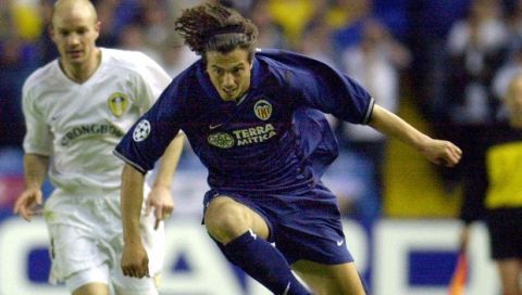 Valencia's Zlatko Zahovic leaps over Leeds United's Lee Bowyer during the UEFA Champion's League first leg semi final match at Elland Road Stadium in Leeds, England, Wednesday May 2, 2001. The match ended in a scoreless draw. (AP Photo/Paul Barker)