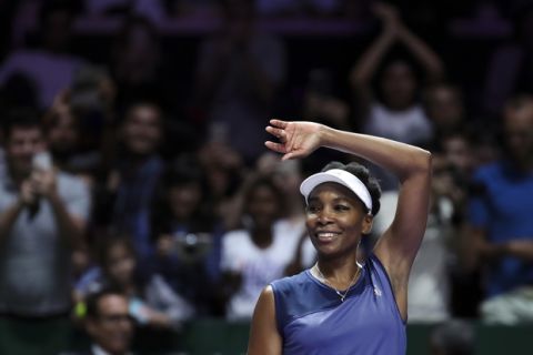 Venus Williams of the United States celebrates after beating Caroline Garcia of France, during their semifinal match at the WTA tennis tournament in Singapore, on Saturday, Oct. 28, 2017. (AP Photo/Yong Teck Lim)