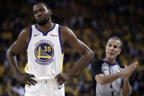 Golden State Warriors' Kevin Durant, left, walks away from referee Ken Mauer during the first half of Game 5 of the team's second-round NBA basketball playoff series against the Houston Rockets on  Wednesday, May 8, 2019, in Oakland, Calif. (AP Photo/Ben Margot)